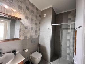 a bathroom with a shower and a toilet and a sink at Rıversıdelıfe Iskele 164 in Vuda +24 photos