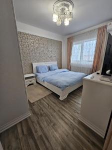 a bedroom with a bed and a television in it at Rowlands Way 1 in Ţegheş +24 photos