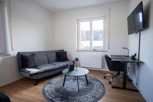 a living room with a couch and a table at JS-Business in Balingen