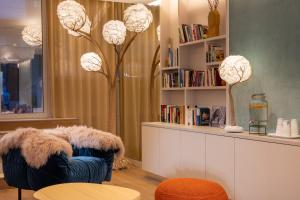 a room with two chairs and a shelf with books at Paris Bastille in Paris