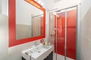 a bathroom with a sink and a shower at Excelsior in Piombino +38 photos