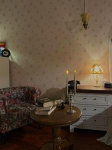 a living room with a table with candles on it at 221B Baker in Ấp Phú Thọ