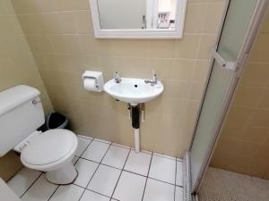 a bathroom with a toilet and a sink at Rosscarbery 6 in Margate +24 photos