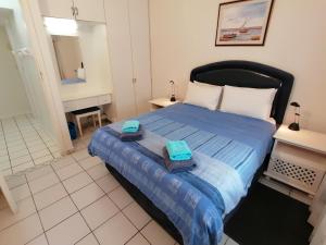 a bedroom with a bed with two towels on it at Rosscarbery 6 in Margate