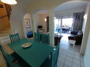 a dining room and living room with a green table and chairs at Rosscarbery 6 in Margate