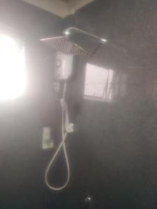 a ceiling light with a hair dryer in a room at Solace Transit Villa in Katunayaka
