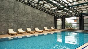 a swimming pool with lounge chairs and a swimming pool at Residence Inn by Marriott Trabzon in Trabzon