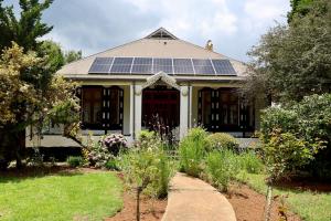 a house with solar panels on the roof at The Dullstroom Inn in Dullstroom