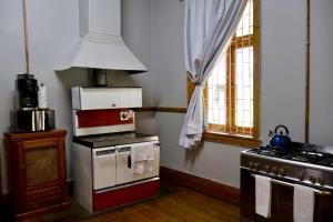 a kitchen with a stove and a stove top oven at The Dullstroom Inn in Dullstroom