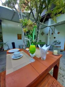 a table with a plate and a green glass at Avalon Villa Unawatuna in Unawatuna