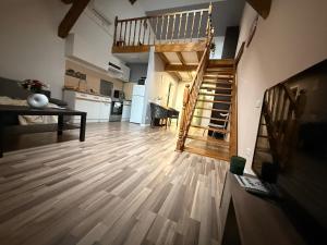 a living room with a wooden floor and stairs at OLD TOWN Palatul Agoston Galgon in Timişoara