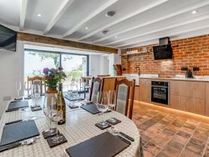 a dining room with a table with wine glasses at Ty Gladys in St. Davids