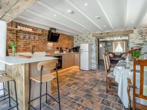 a kitchen with a counter and a table with chairs at Ty Gladys in St. Davids