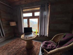 a laptop computer sitting on a table in a room with a window at Enter The Wild in Kalgha