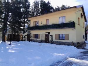 a house with a pile of snow in front of it at B&B Nonna Iolanda in Camigliatello Silano