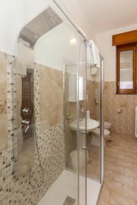 a bathroom with a shower and a toilet and a sink at Sisters Hotel in Piano di Sorrento +152 photos
