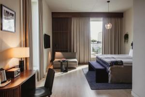 a hotel room with a bed and a desk and a chair at Home Hotel Tapetfabriken in Stockholm +78 photos