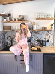 a woman sitting on a kitchen counter holding a spoon at Secret place in Svalyava +11 photos