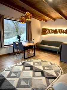 a living room with a table and chairs and a couch at Secret place in Svalyava