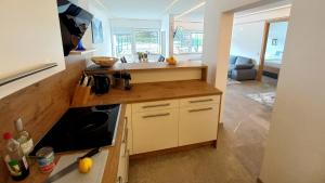 a kitchen with a sink and a counter top at Luxus Terrassenappartement Berg & See 1 in Bodensdorf