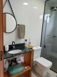 a bathroom with a sink and a toilet and a shower at Chalé Céu Estrelado in Paraisópolis +29 photos
