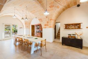 a kitchen and dining room with a white table and chairs at Masseria Lovetere Rooms - Salento Selection in Copertino +49 photos