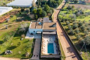 an aerial view of a house with a swimming pool at Masseria Lovetere Rooms - Salento Selection in Copertino