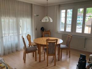 a dining room with a wooden table and chairs at Appenzellerland Schöne Wohnung in einem Wandergebiet in Teufen
