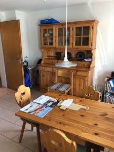 a dining room with a wooden table with chairs at Appenzellerland Schöne Wohnung in einem Wandergebiet in Teufen