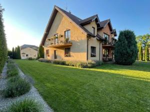 a large house with a green lawn in front of it at Villa Morska Perła in Rewal