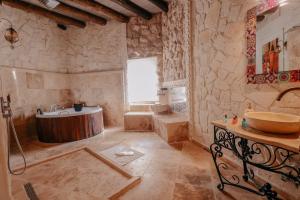 a large bathroom with a tub and a sink at Zümrütü Anka Cave in Ürgüp +55 photos