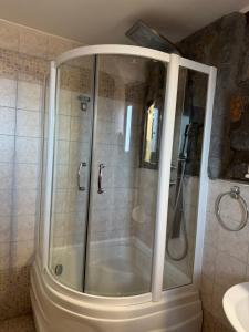 a shower with a glass door in a bathroom at ΞΕΝΩΝΑΣ ΘΕΑ in Palaios Agios Athanasios +65 photos