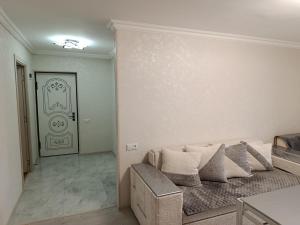 a living room with a couch and a door at Jermuk Calm House in Jermuk