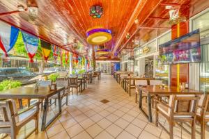 a dining room with tables and chairs in a restaurant at Cleopatra Ada Apart & Suites Hotel in Alanya