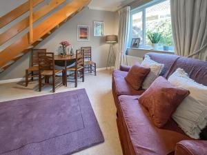 a living room with a couch and a table at Lavender Cottage in Louth