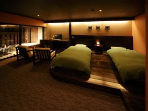 a hotel room with two beds and a desk at かね吉一燈庵 in Mitaka +55 photos