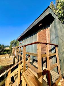 a wooden ramp leading to a wooden building at Tiny House Pangal in Pichilemu +10 photos