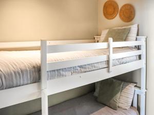 two bunk beds in a small room with a bed at The Lookout in Pendine