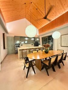 a dining room with a large wooden table and chairs at Hansa Villa in Weligama