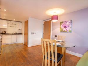 a dining room and kitchen with a table and chairs at 206 By The Bridge Apartment in Inverness