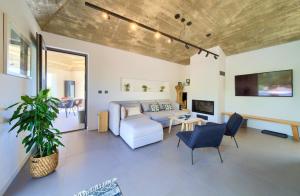a living room with a couch and a table at Margari Villas in Linardići