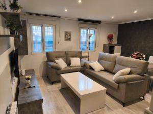 a living room with two couches and a coffee table at Living Canovas in Alcalá de Henares