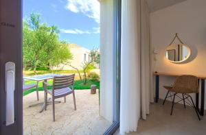 a view of a patio with a table and chairs at Margari Villas in Linardići
