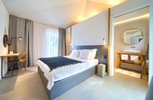 a bedroom with a bed and a sink and a mirror at Margari Villas in Linardići +42 photos