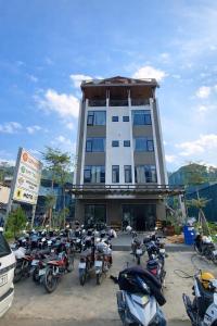 a group of motorcycles parked in front of a building at Cozy Hostel and Tours in Ha Giang