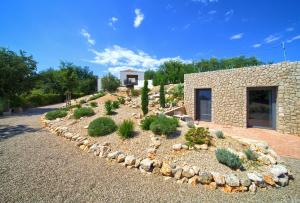 a garden with plants in front of a building at Margari Villas in Linardići