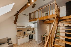 a kitchen with a staircase leading up to a loft at OLD TOWN Palatul Agoston Galgon in Timişoara