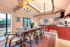 a kitchen and dining room with a wooden table and chairs at 3 Bed in Ringsfield oc-m33329 in Wingfield
