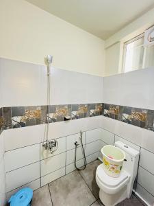 a bathroom with a toilet and a shower at Homey - vythiri bus station in Vythiri +45 photos