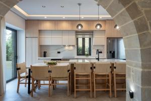 an open kitchen with a dining table and chairs at Golden Silence in Platanias